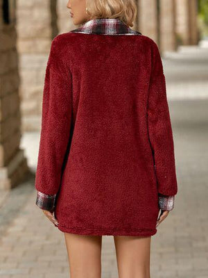 a woman in a red coat is walking down the street