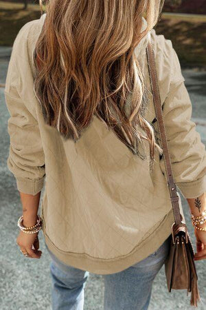 a woman walking down a street holding a purse