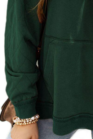 a woman wearing a green jacket and a bracelet
