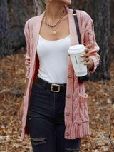 a woman in a pink cardigan holding a cup of coffee