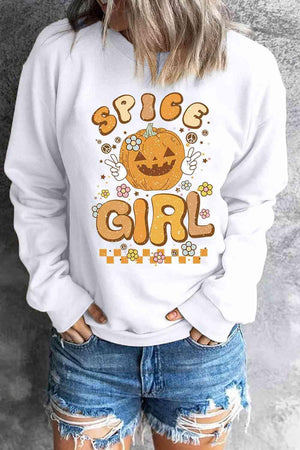 a woman wearing a white sweatshirt with a pumpkin on it