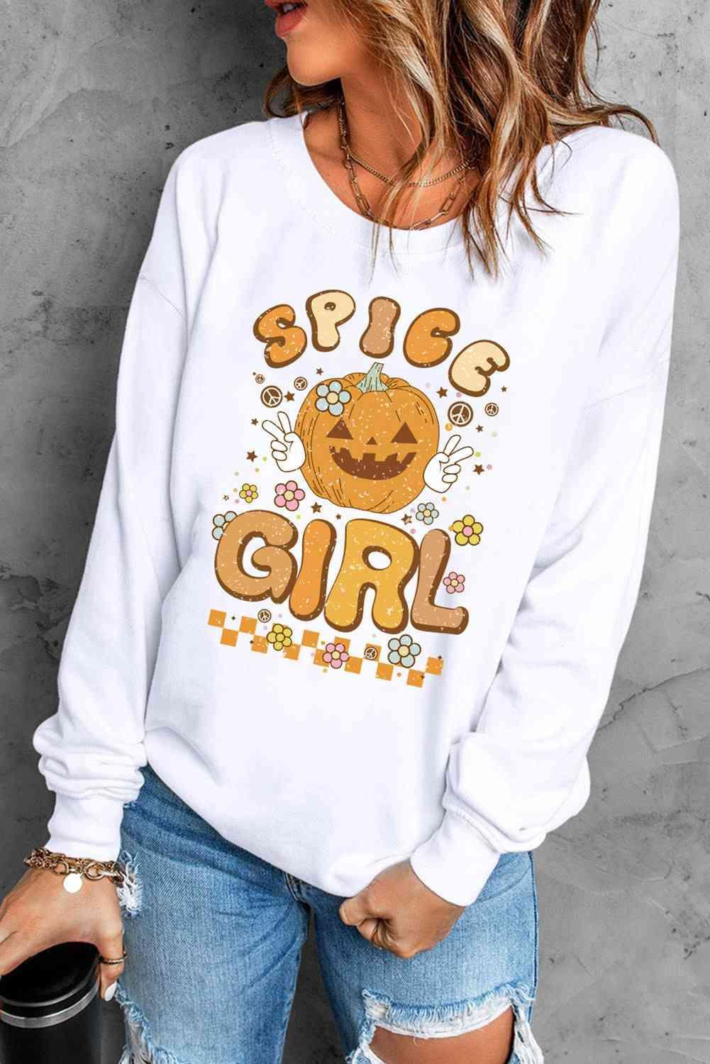 a woman wearing a white sweatshirt with a pumpkin on it