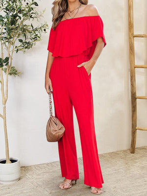a woman in a red jumpsuit posing for a picture