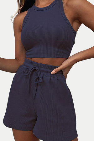 a woman wearing a crop top and shorts