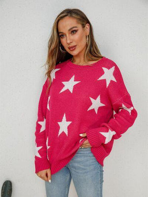 a woman wearing a pink sweater with white stars on it