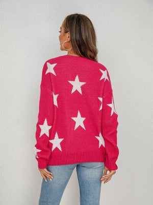 a woman wearing a pink sweater with white stars on it