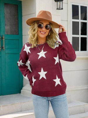a woman wearing a star sweater and hat