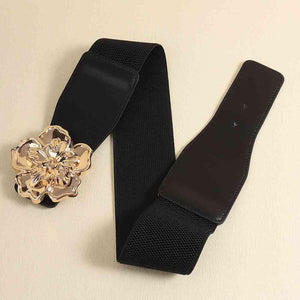 a black belt with a gold flower buckle