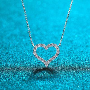 a heart shaped necklace on a blue background