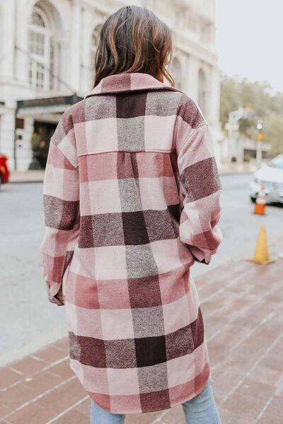 a woman walking down the street in a plaid coat