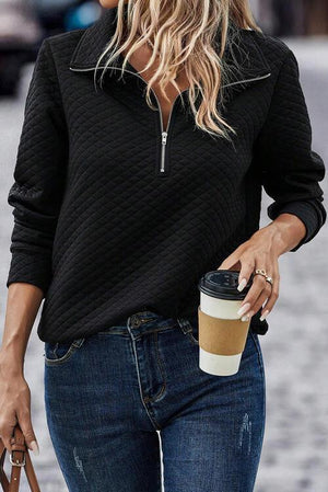 a woman walking down the street with a coffee in her hand