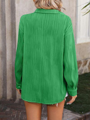 a woman wearing a green shirt and shorts