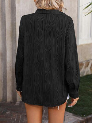 a woman wearing a black shirt and shorts