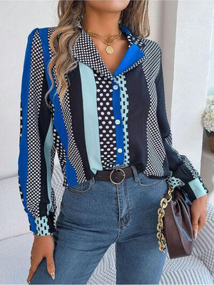 a woman wearing a blue and black shirt and jeans