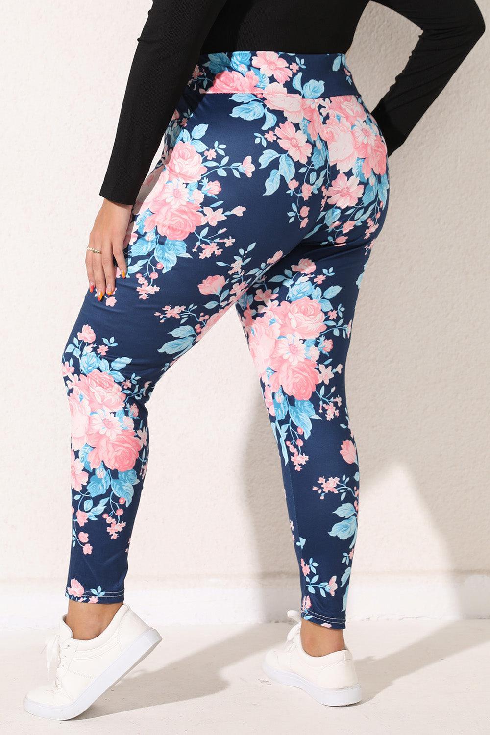 a woman in a black top and floral print leggings
