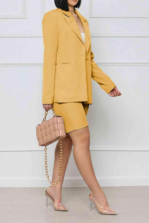 a woman in a yellow suit and heels