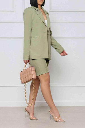 a woman in a green suit and heels