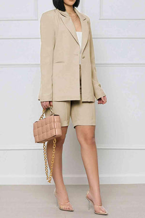 a woman in a tan suit holding a pink purse