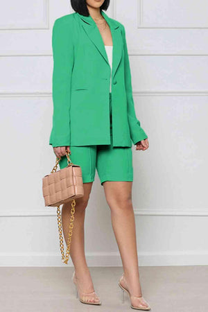 a woman in a green suit holding a purse