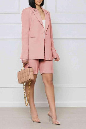 a woman wearing a pink suit and heels