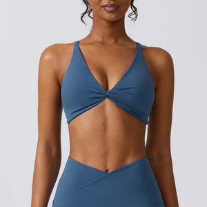 a woman wearing a blue bikini top with a cross back