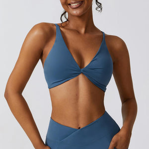a woman in a blue bikini top with her hands on her hips