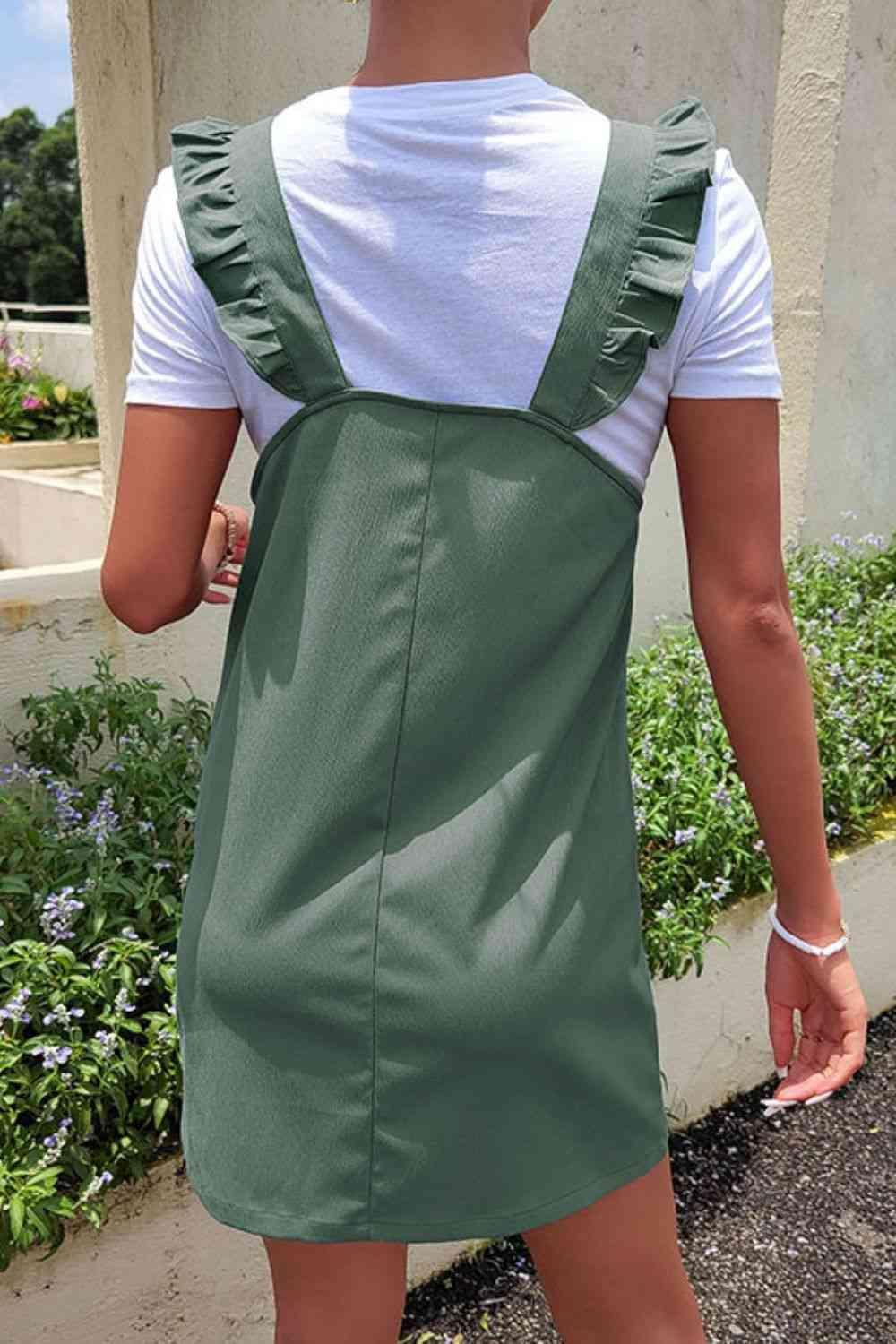 a woman wearing a green dress and white shirt