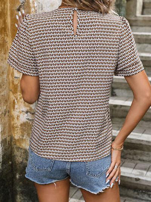 a woman wearing a short sleeved shirt and denim shorts