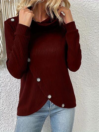 a woman wearing a red sweater and jeans