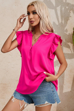 a woman in a pink top posing for a picture
