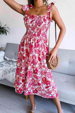 a woman in a pink floral dress holding a purse