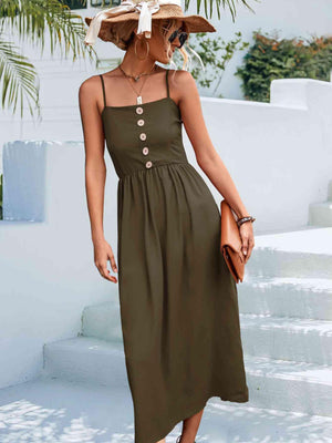 a woman wearing a green dress and a straw hat