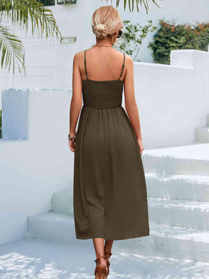 a woman in a brown dress walking down some steps