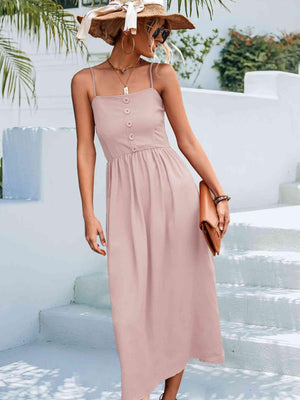 a woman wearing a pink dress and a straw hat