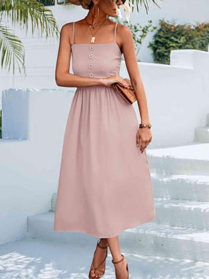 a woman wearing a pink dress and hat