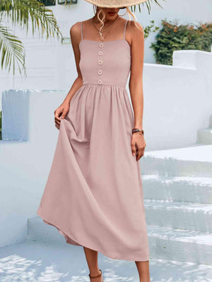 a woman wearing a pink dress and a straw hat