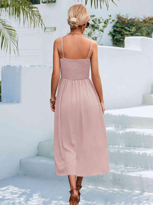 a woman in a pink dress walking down stairs