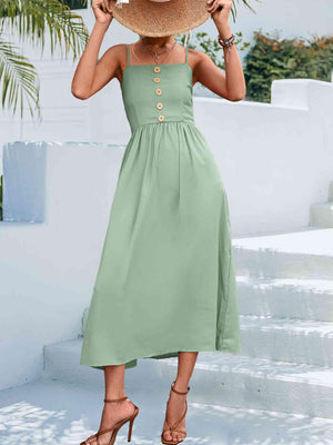 a woman wearing a green dress and a straw hat