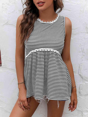 a woman wearing a black and white striped romper