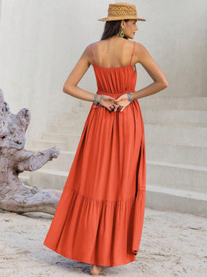 a woman in an orange dress and straw hat