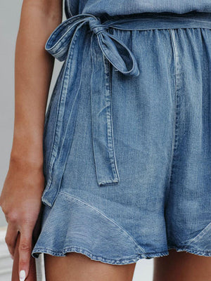 a close up of a person wearing a jean shorts