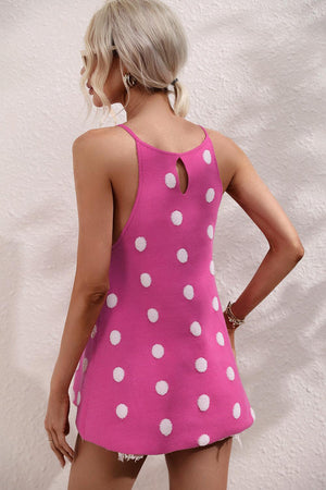 a woman in a pink and white polka dot dress