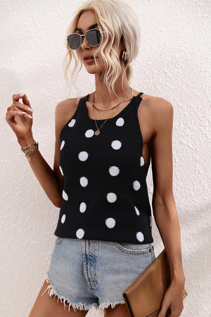 a woman wearing a black and white polka dot top