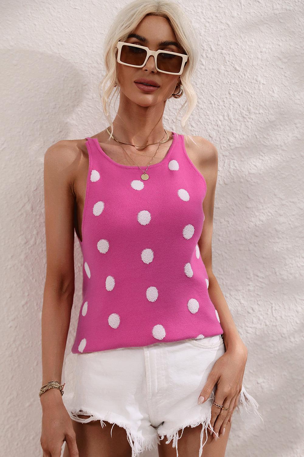 a woman wearing white shorts and a pink tank top
