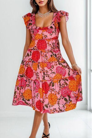 a woman in a pink dress standing in front of a window