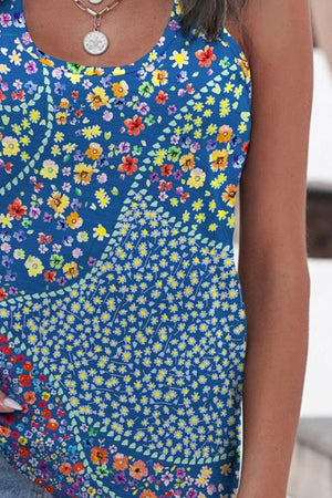 a woman wearing a blue tank top with flowers on it