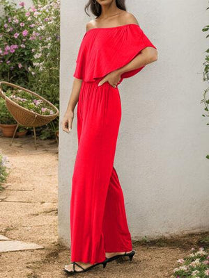 a woman in a red dress posing for a picture
