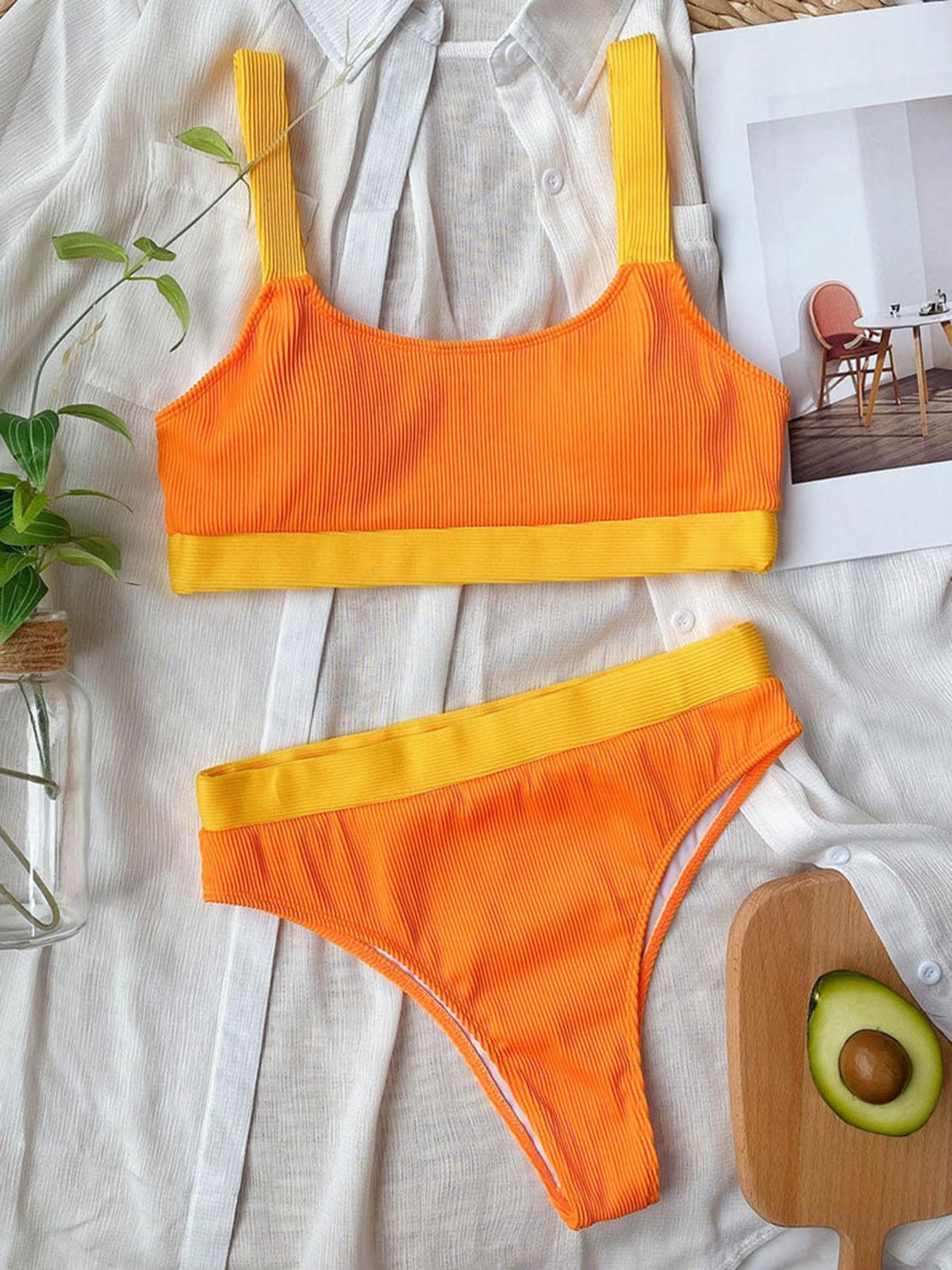 a woman's orange and yellow two piece swimsuit and an avocado