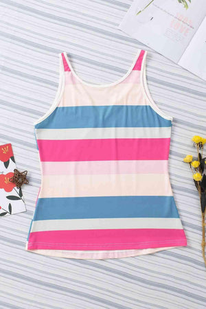 a pink, blue, and white striped tank top next to flowers