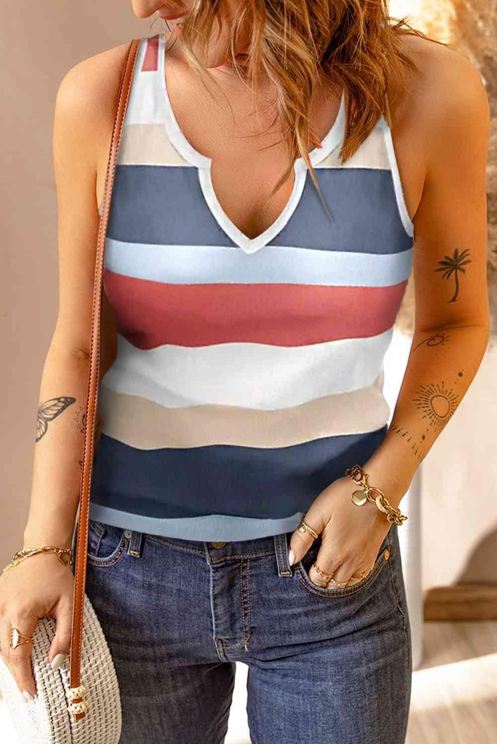 a woman in a striped tank top holding a purse